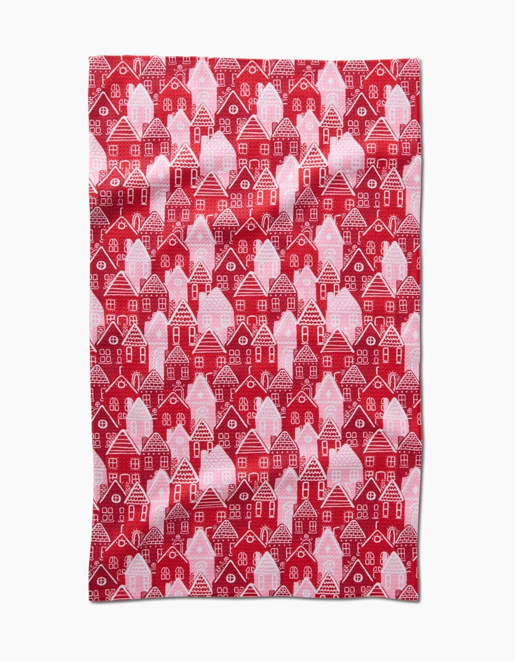 Holiday tea towel with waffle weave construction in red featuring a festive pattern.