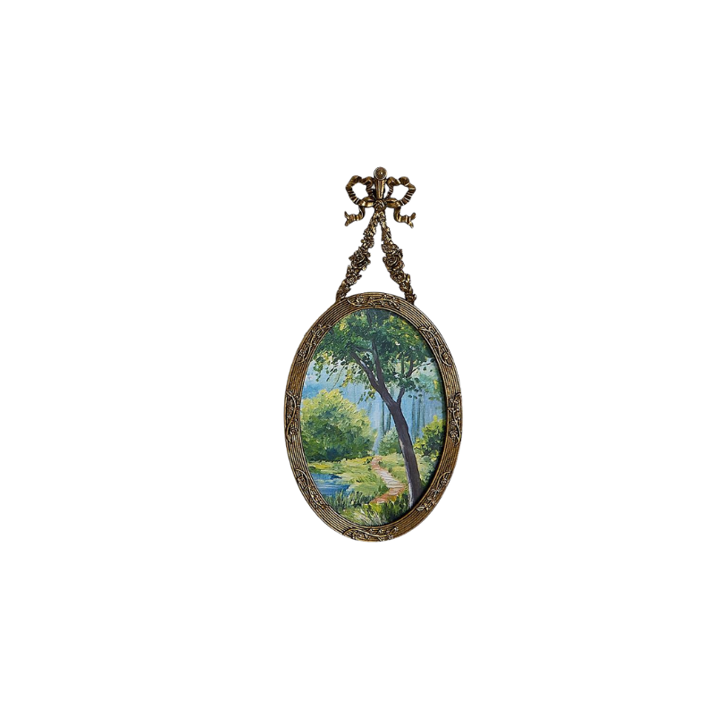 Antique pewter oval frame with bow and flower detail, featuring a painted landscape scene.