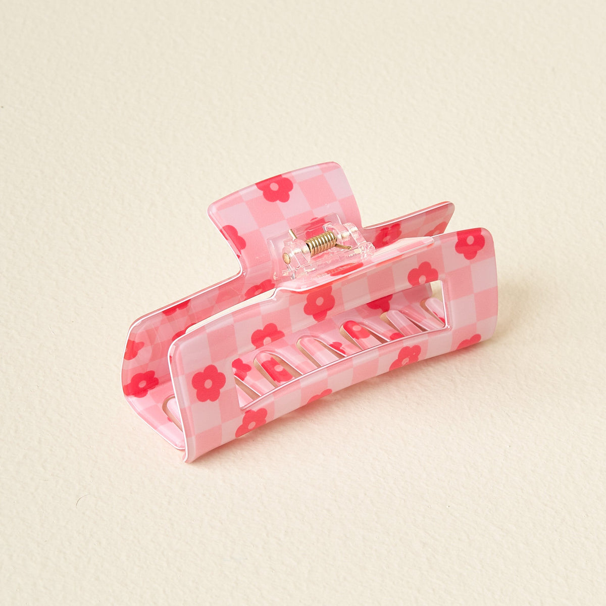 Clear plastic check claw clip with printed checkerboard pattern