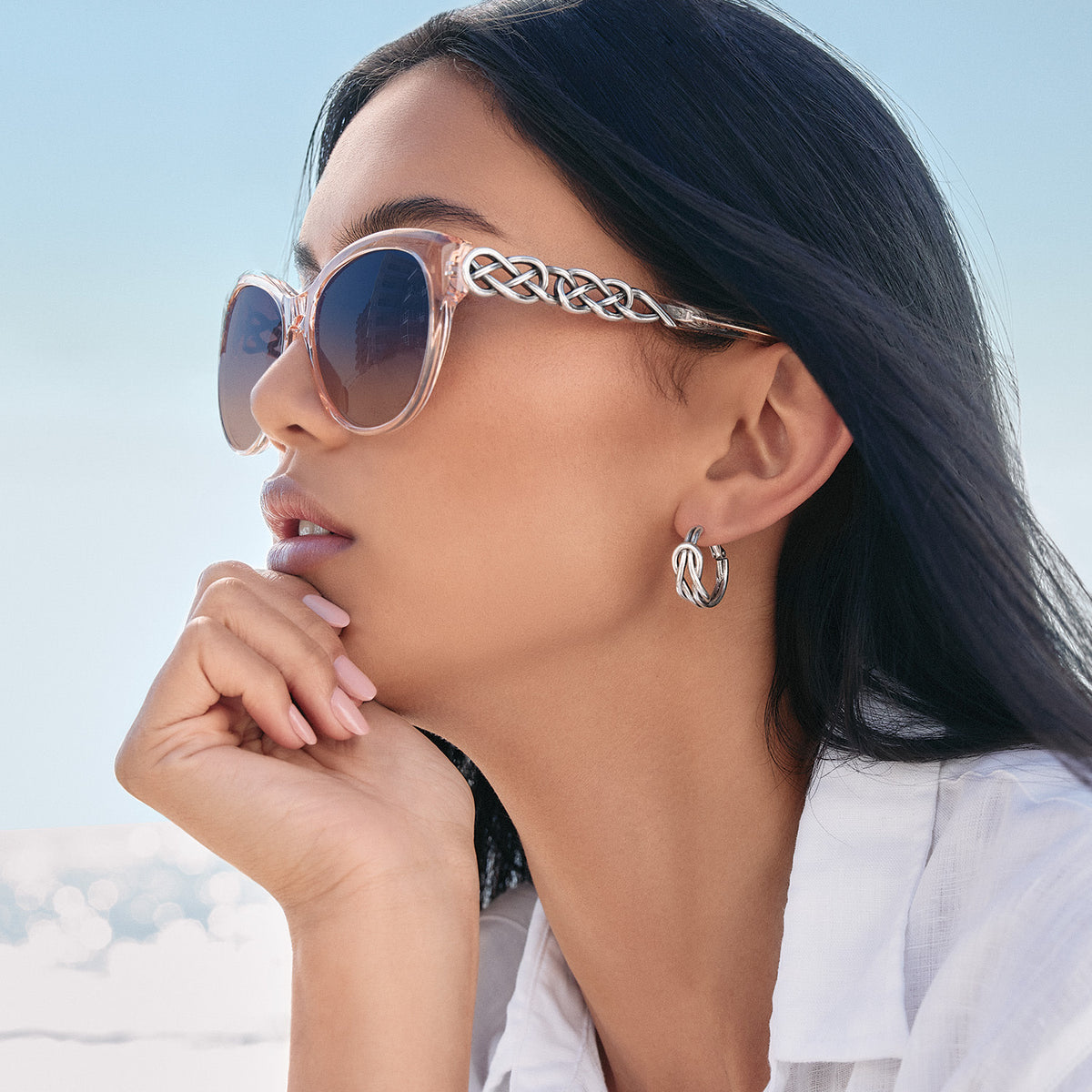Rosewater cat-eye sunglasses with silver-plated accents and an interlok braid pattern on the temples.
