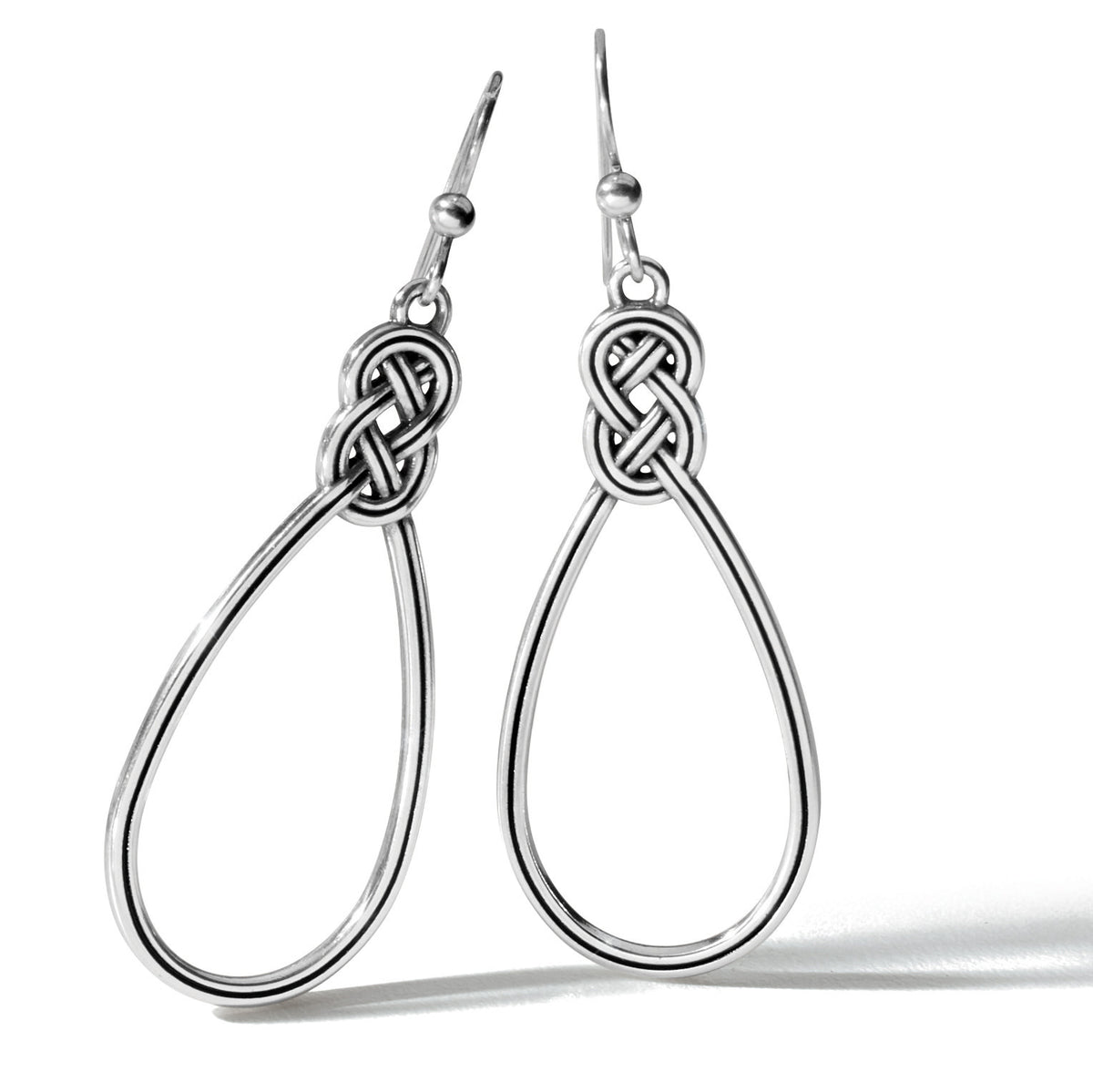 Silver plated French wire earrings featuring an interlocking Celtic knot teardrop hoop with a two-inch drop.