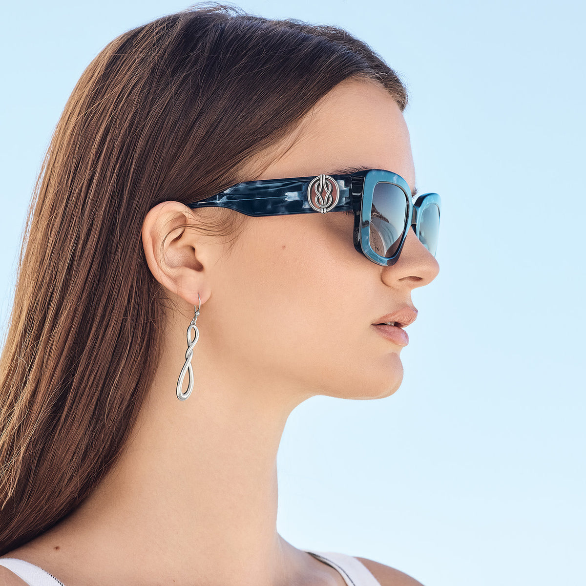 Interlok Harmony Blue Crush square sunglasses with wide mottled blue frames, silver accents, and rectangular silhouette.