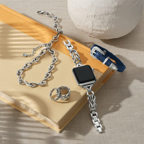 Silver Interlok Harmony watch band with fold-over clasp extenders on a white background.