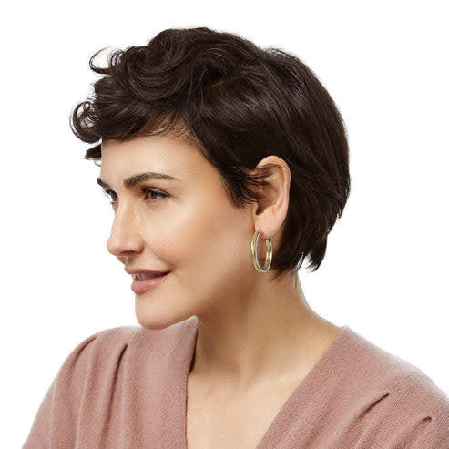 Two-tone gold-silver Interlok Noir hoop earrings with fine etched textured lines on the silver edge.