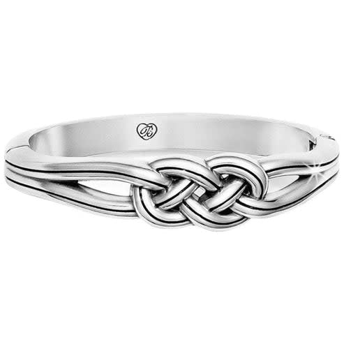 Silver plated hinged bangle with magnetic closure featuring a Celtic-inspired oval silhouette.