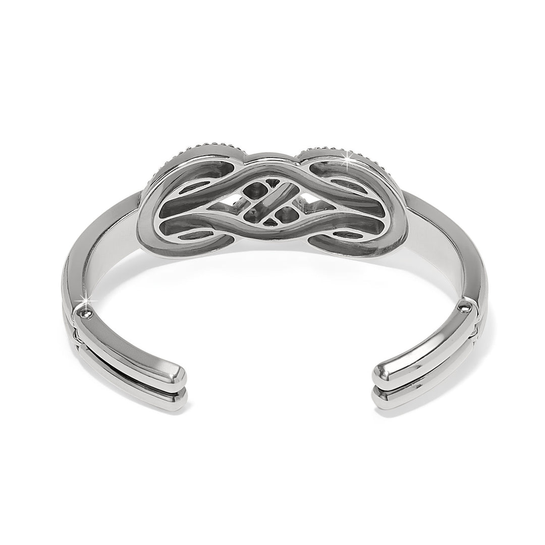 Silver hinged bangle with encrusted crystal infinity symbol pattern