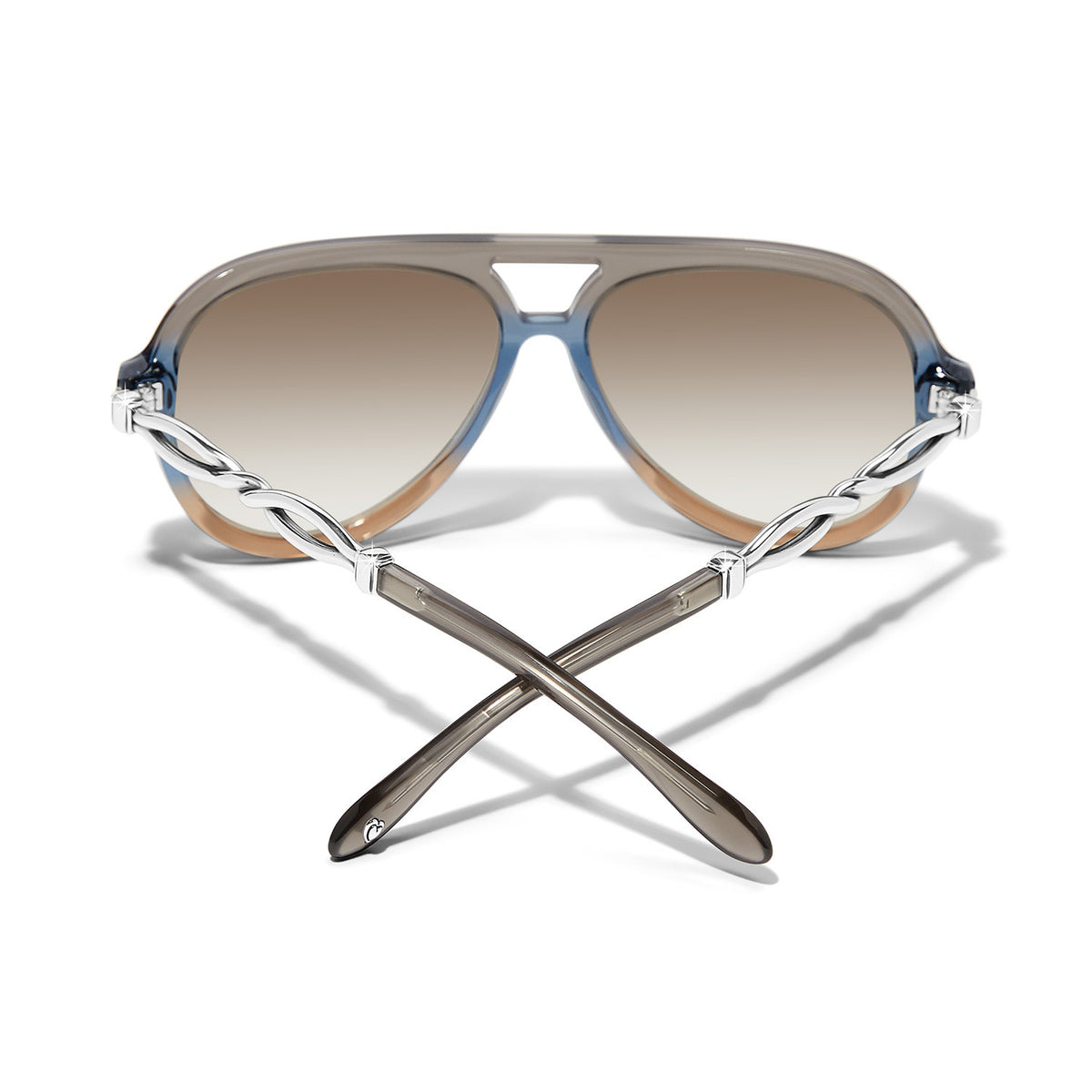 Interlok Twist aviator sunglasses with tan acetate frames, blue lenses, silver accents, and UVA/UVB protection.