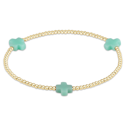 Signature Cross gold-filled bracelet with a cross bead pattern on elastic cord