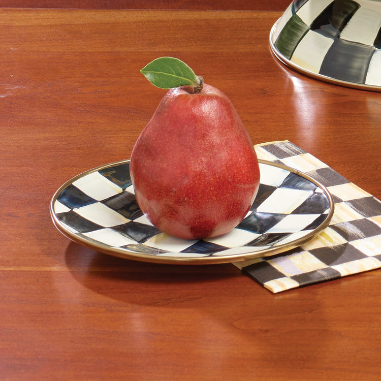 Courtly Check Enamel Saucer with a hand-painted black and white pattern and bronzed steel rim.