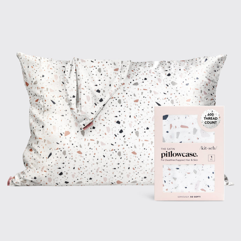 Satin pillowcase in a soft neutral tone with smooth texture.