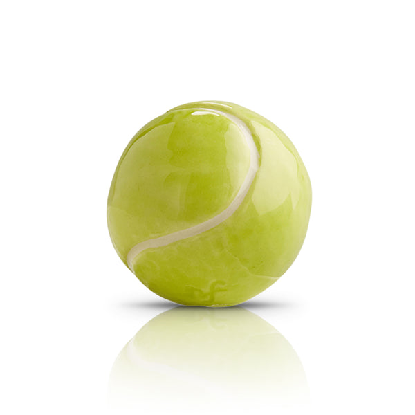 Glossy lime green ceramic tennis ball figurine with white seam detail and reflection.