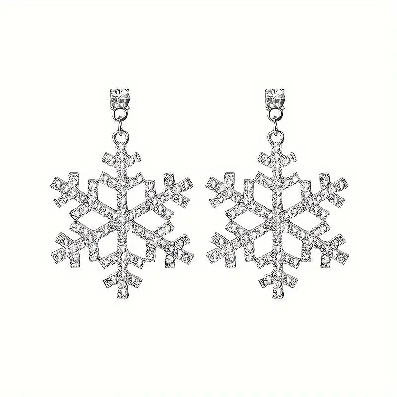 Silver snowflake dangle earrings with sparkling rhinestone accents.