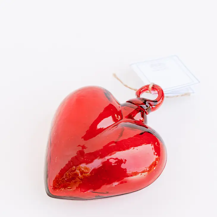Hand-blown glass heart pendant in translucent amber with smooth organic curves.