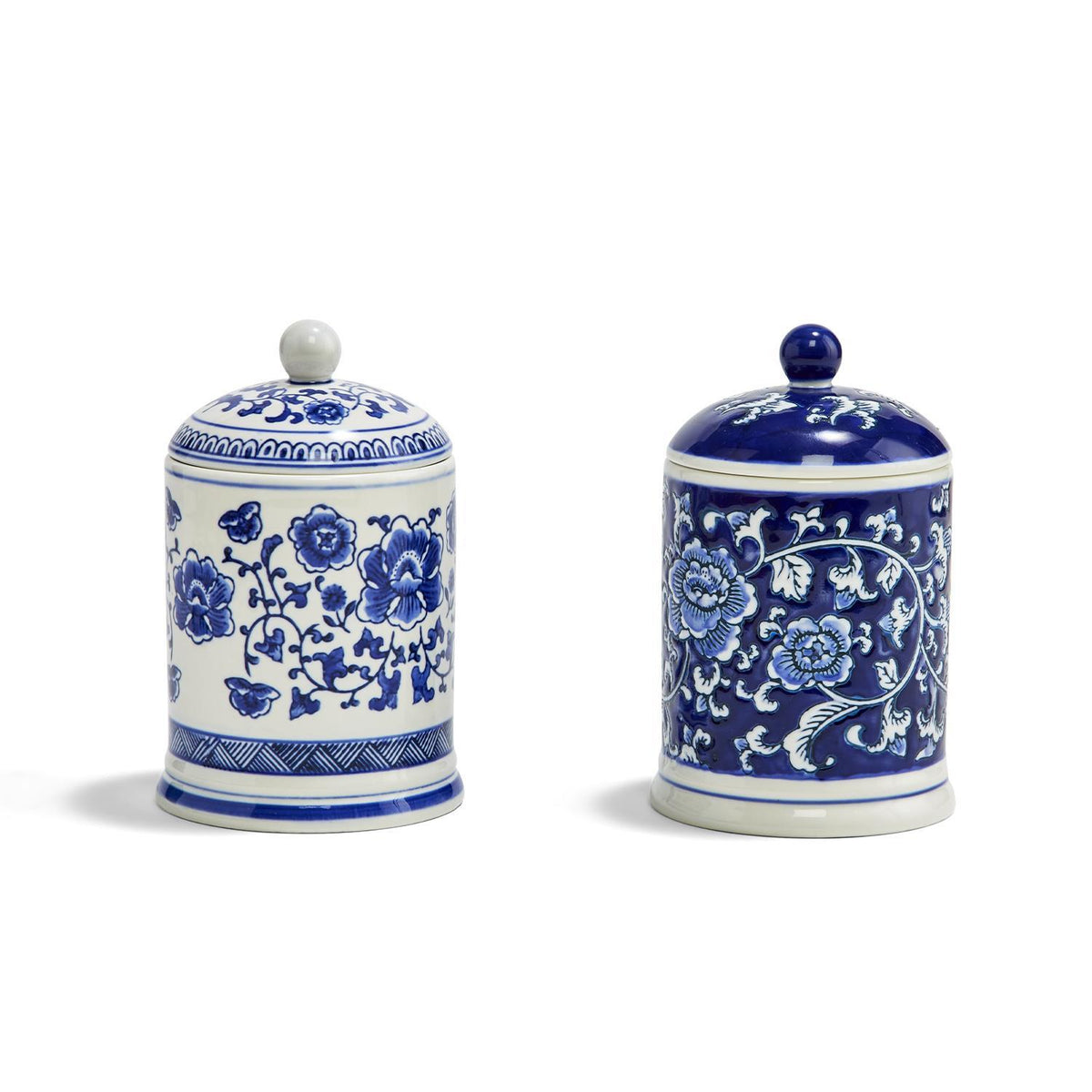 Two blue and white ceramic Canton Collection candles with floral patterns and lids.