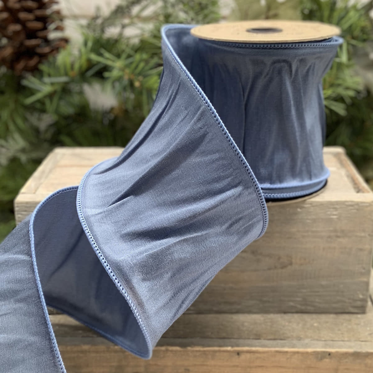 Blue New Taffeta ribbon roll with smooth satin finish.