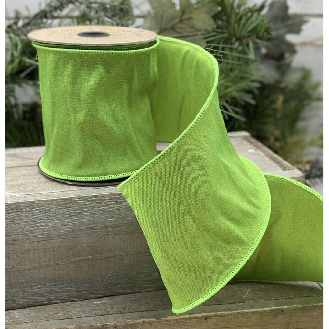 Lime green taffeta ribbon roll with a smooth satin finish.