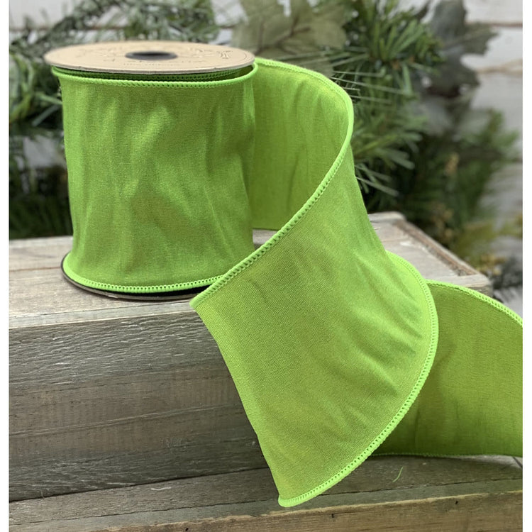 Lime green taffeta ribbon roll with a smooth satin finish.