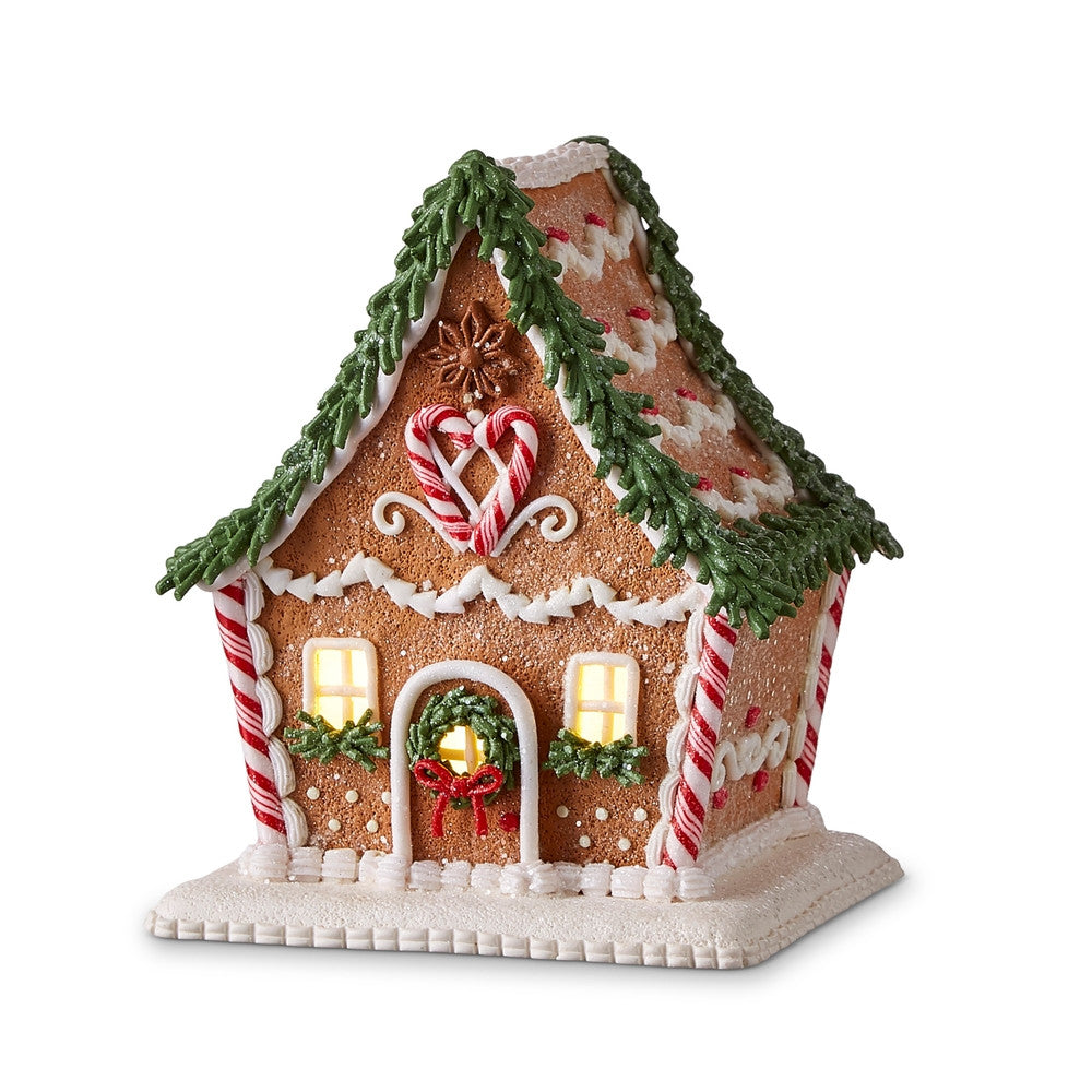 6.5-inch lighted gingerbread house with candy cane accents and green frosting garland.