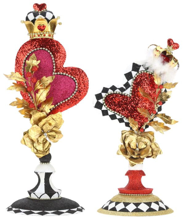 Black metal finial with a decorative scrollwork top.