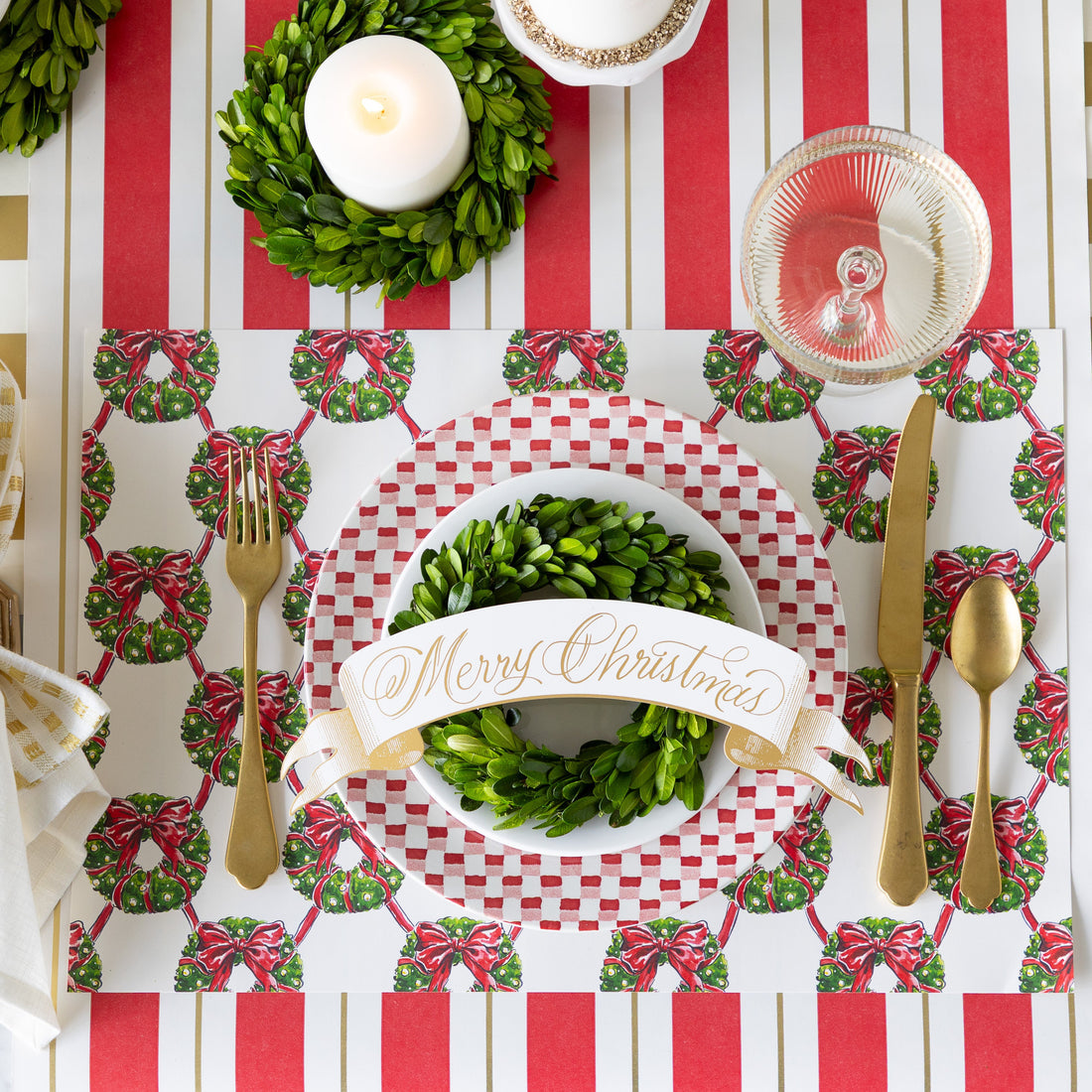 Red Christmas banner table accent with white snowflake patterns on a scalloped silhouette.