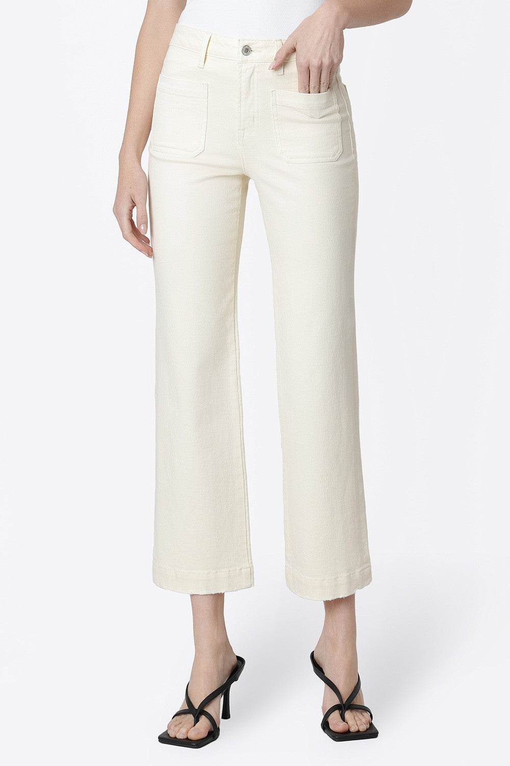 Woman wearing Ailleah high-rise slim wide leg jeans in natural color with front patch pockets.
