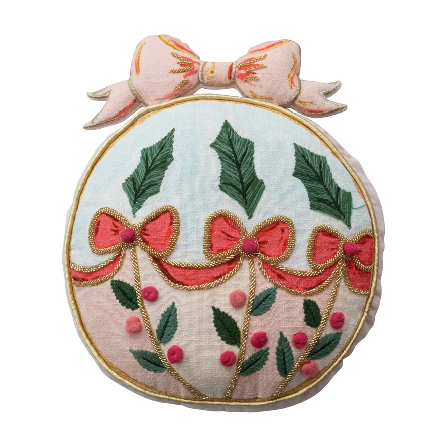 Ornament shaped pillow with embroidered holly leaves, red bows, and a pink velvet bow on top.