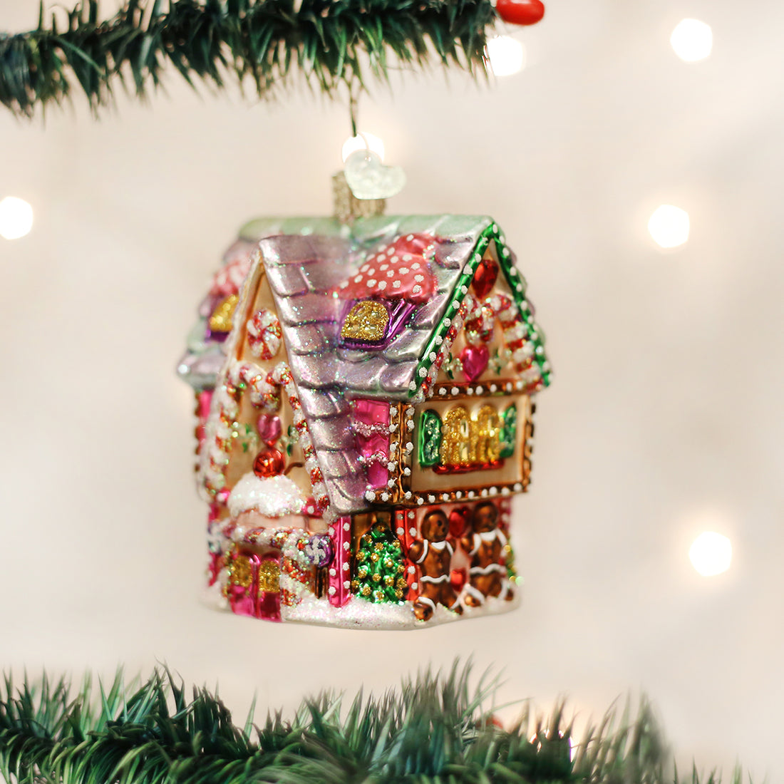 Glass Cupcake Cottage Christmas ornament with glittery pink, purple, and gold candy decorations.