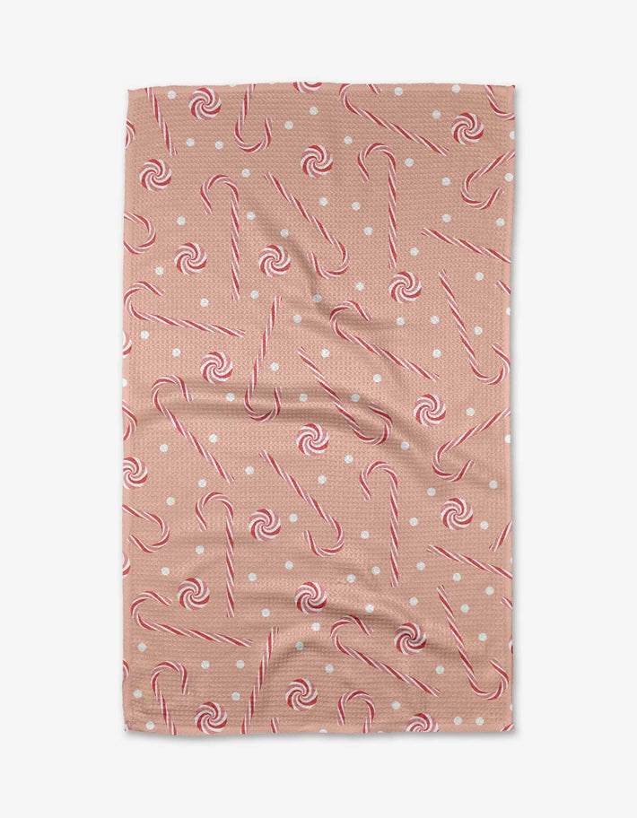 Holiday tea towel with waffle weave construction in red featuring a festive snowman pattern.