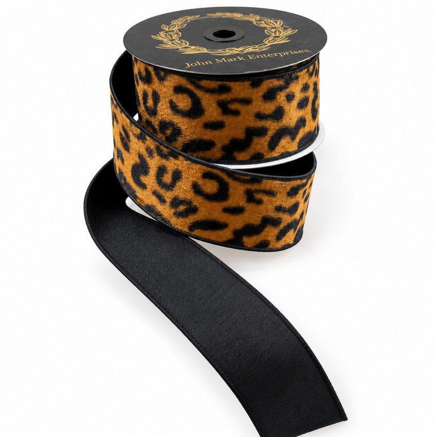 2.5 inch wide leopard print ribbon with black wired edges on a spool.