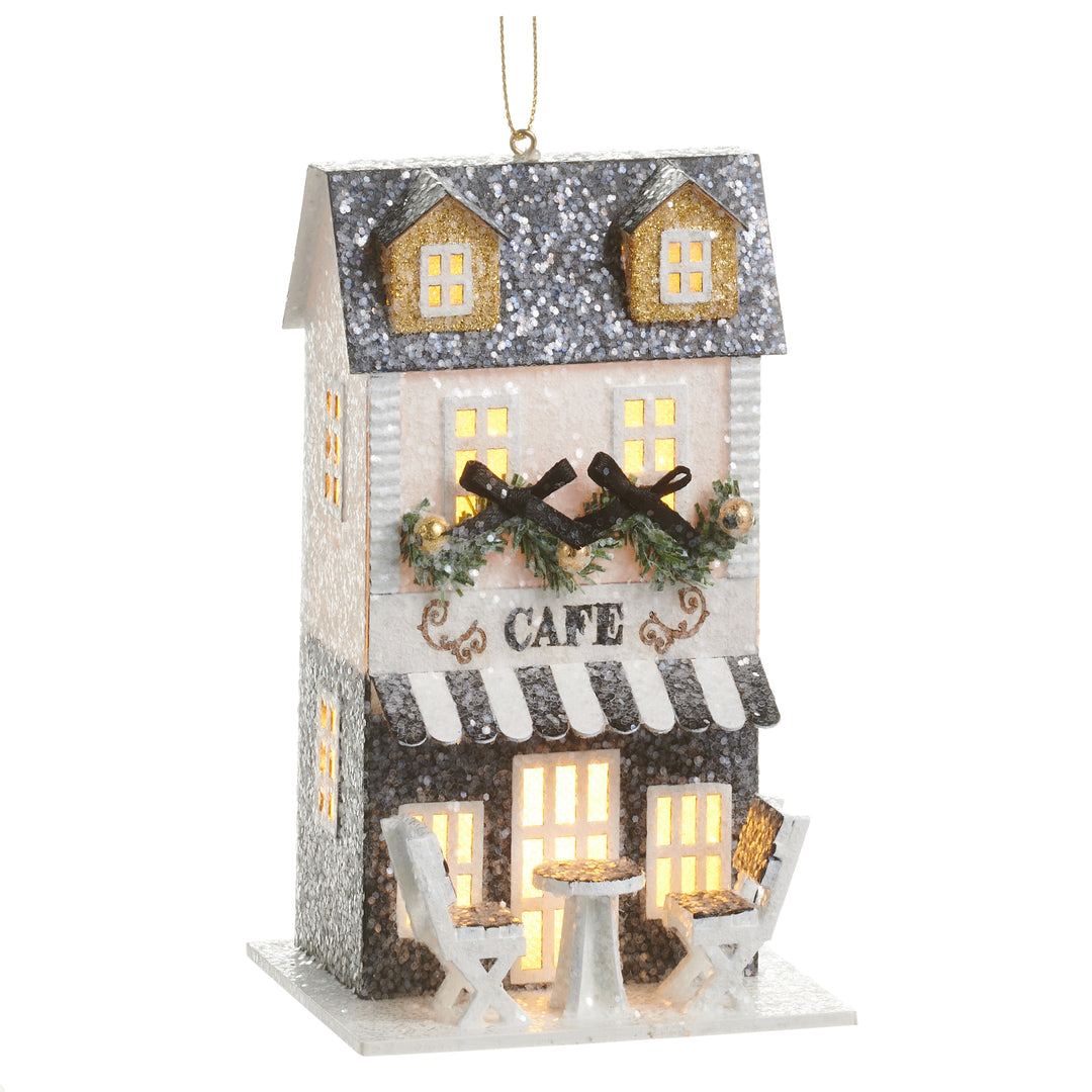 5.5-inch lighted paper cafe ornament with a glittery roof, striped awning, and outdoor seating.
