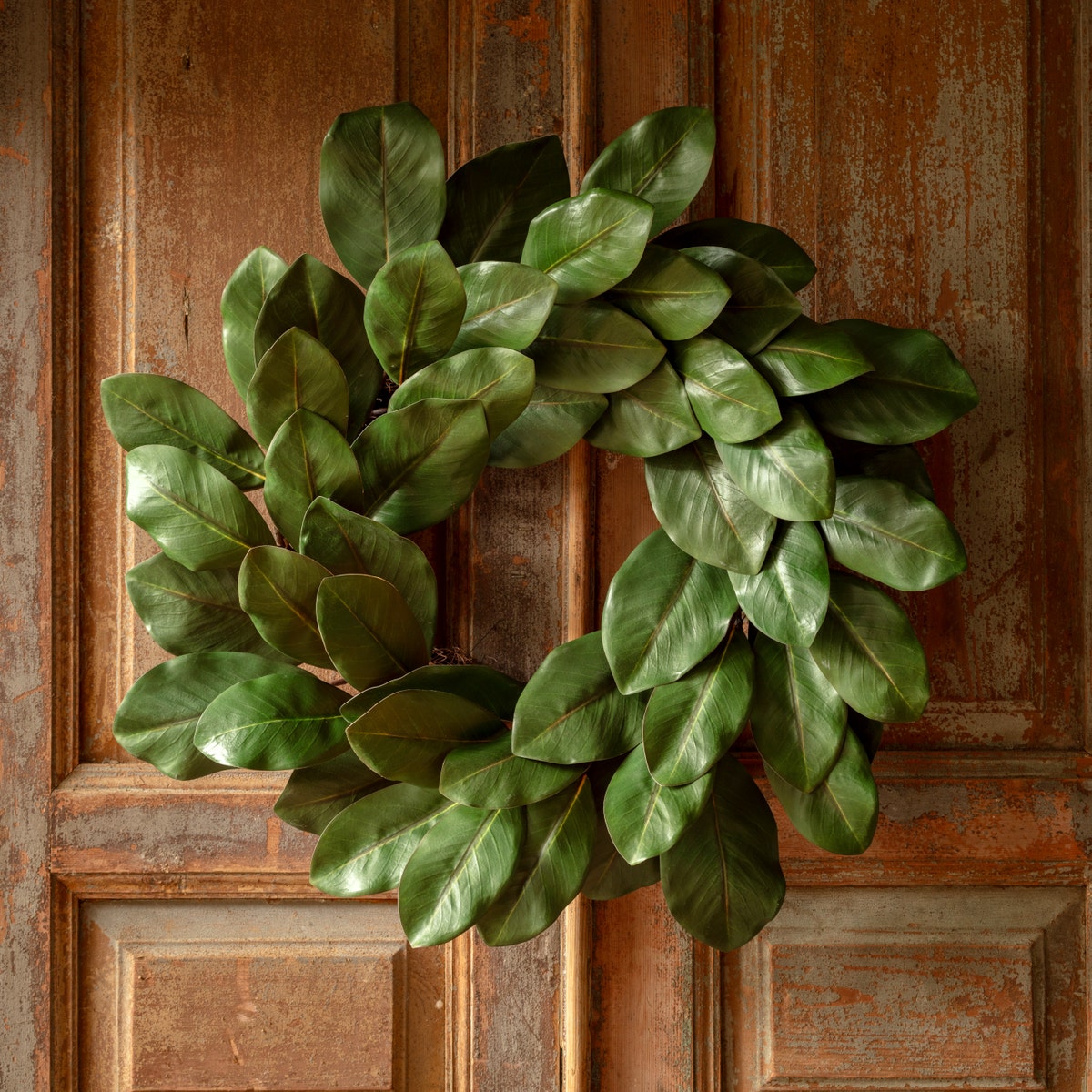 Round Monticello Magnolia wreath with natural green foliage and cream-colored magnolia flower accents.