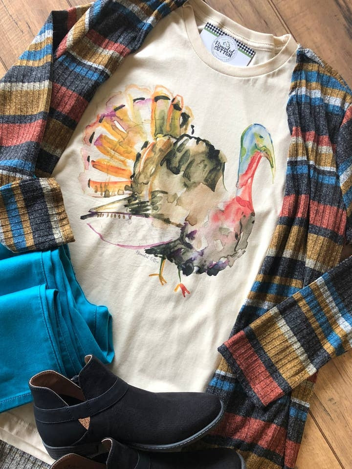 Watercolor Turkey Tee paired with a striped cardigan, teal pants, and black ankle boots.