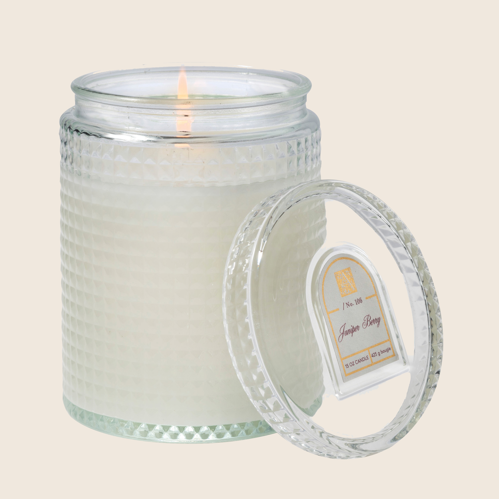 15 oz Juniper Berry candle in a textured glass jar with a lit wick and matching glass lid.