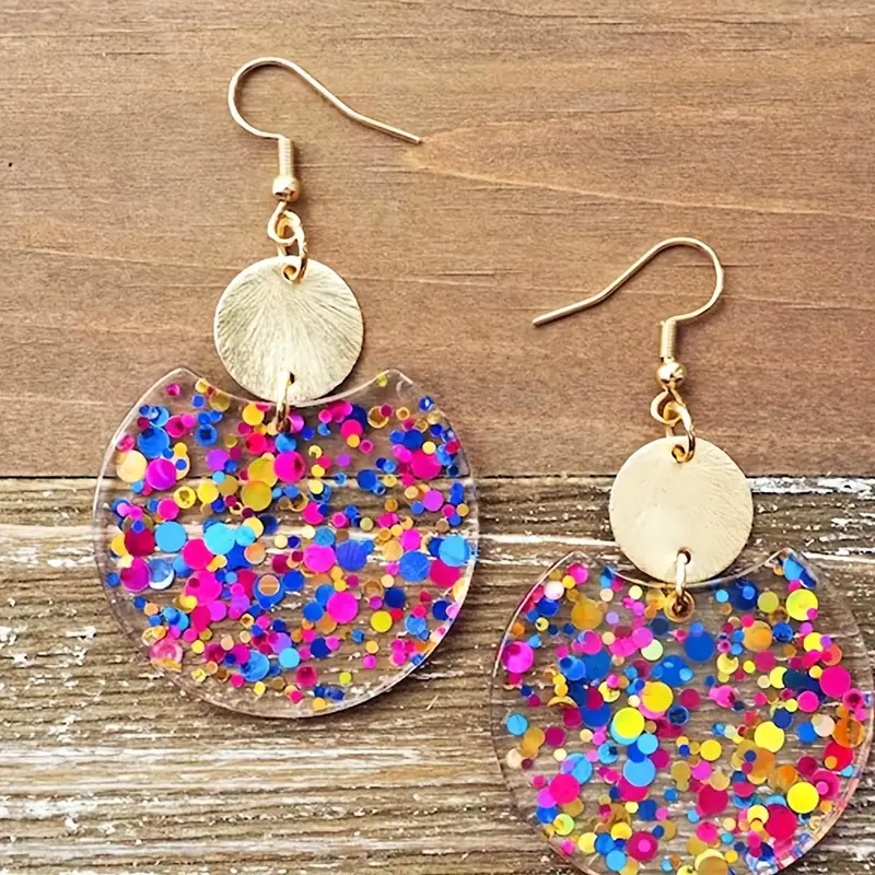 Golden tone circle earrings with vibrant confetti sparkle pattern