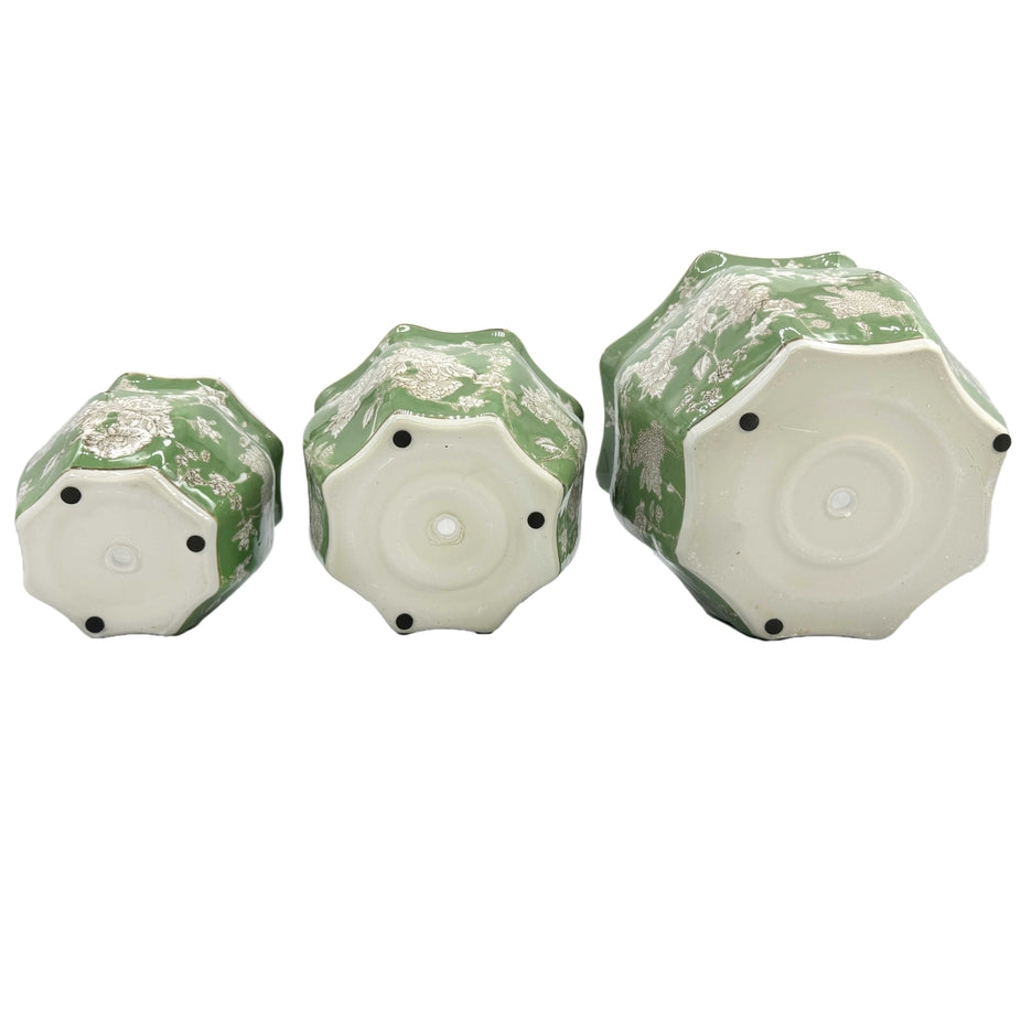 Handcrafted ceramic planter pot in green and white with intricate fluting.