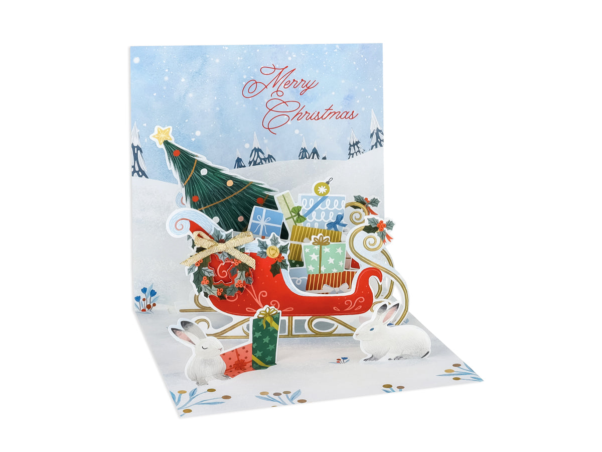 White Christmas sleigh card with red foil finish featuring a festive holiday illustration.