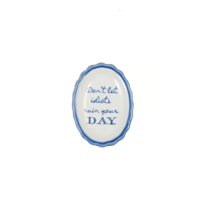 Oval scalloped stoneware dish with blue trim and text reading Don't let idiots ruin your DAY.