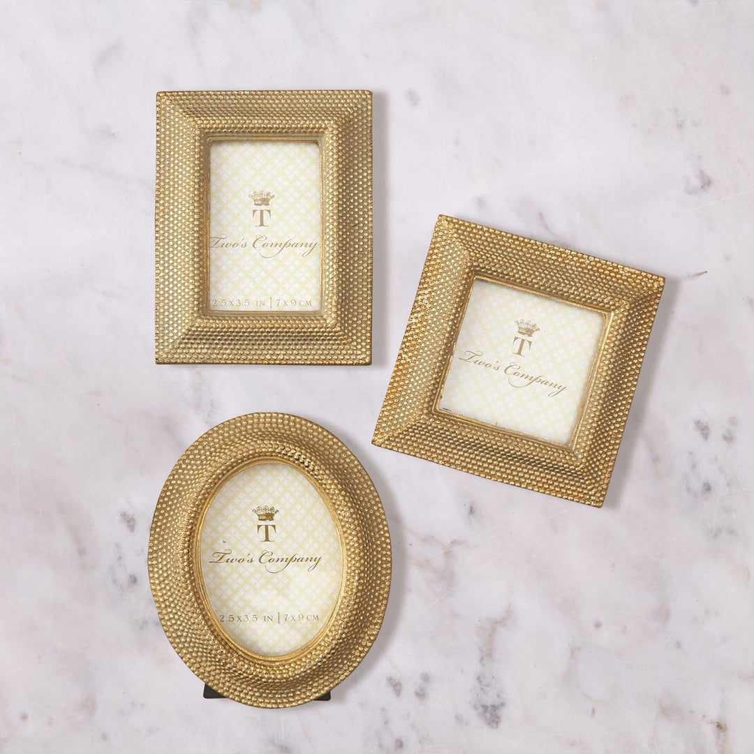 Three Tuileries Golden Dots Photo Frames in rectangular, square, and oval shapes on marble.
