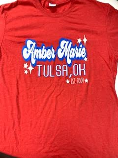 Red t-shirt with "Amber Marie Tulsa, OK Est. 2004" printed in white and blue.