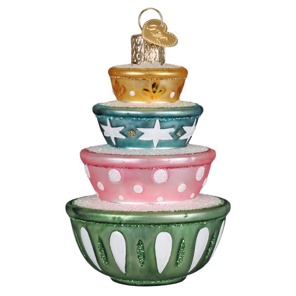 Stacked ceramic mixing bowl ornaments in cheerful holiday colors with whisk handles.