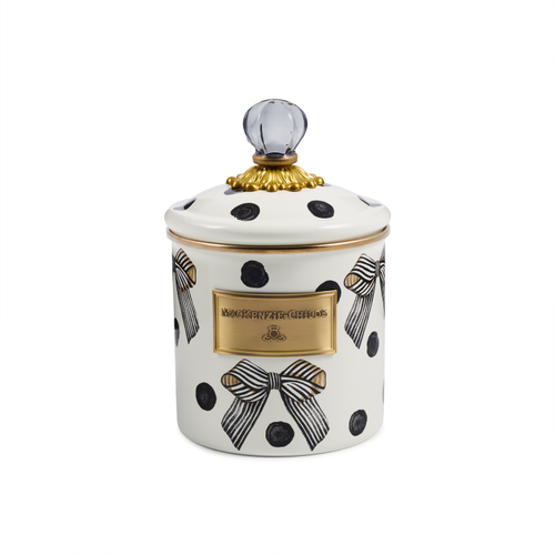 White ceramic canister with black polka dots, striped bows, and a gold-rimmed lid with glass knob.