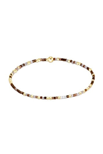 Hope Unwritten bracelet featuring mixed 2mm seed beads in various colors with gold-filled accents on elastic cord.