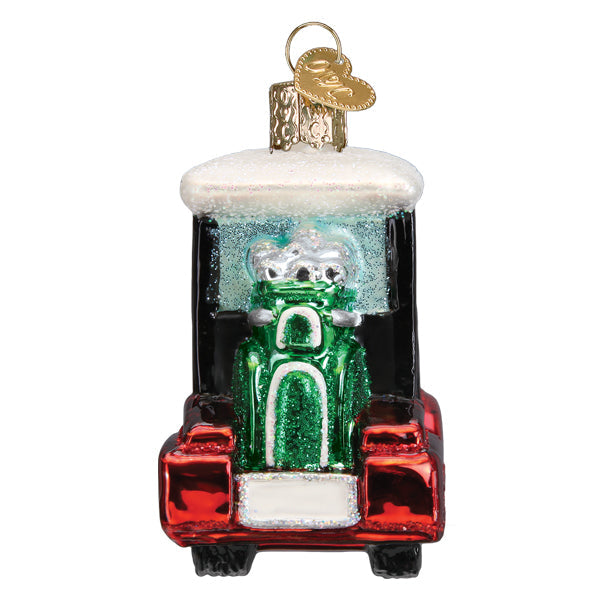 Glass golf cart Christmas ornament with a red body, green golf bag, and white glittery roof.