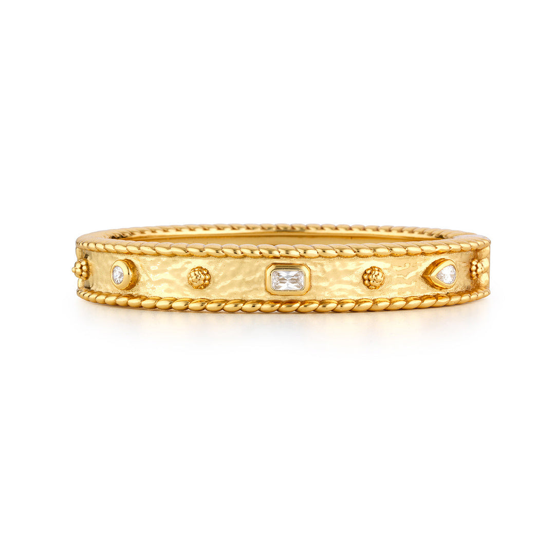 Hinged bangle bracelet with clear cubic zirconia stones set in gold-tone brass.