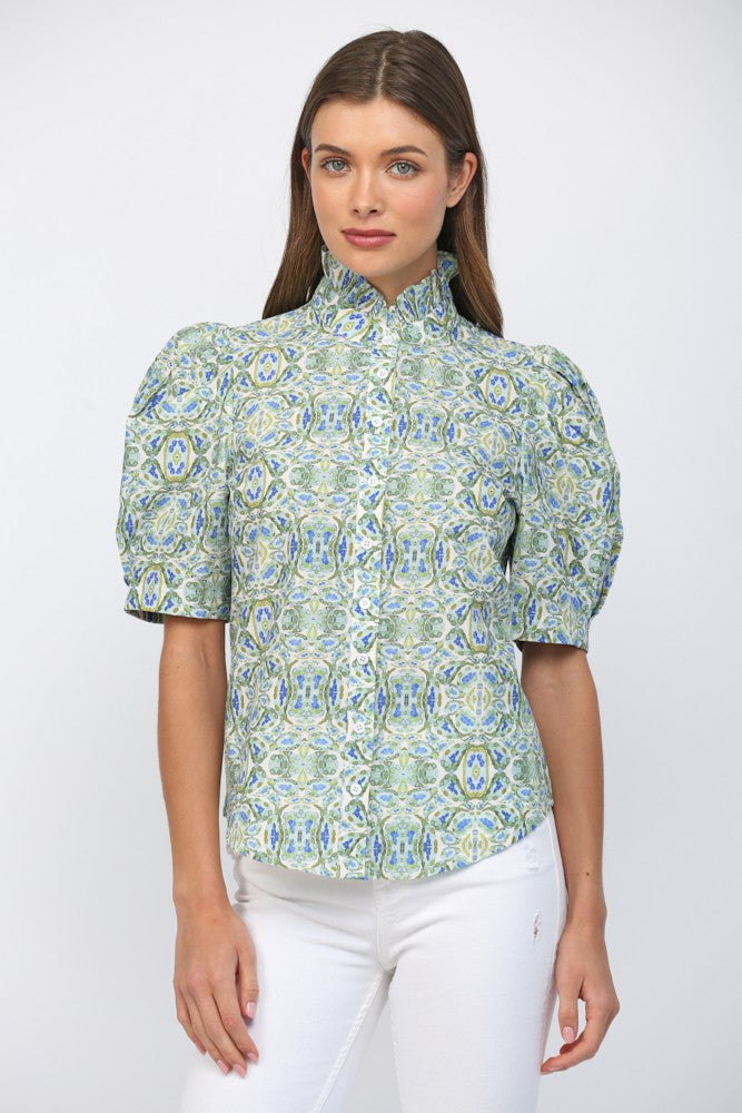 Woman wearing a blue and green patterned Eliana puff short sleeve ruffle neck button down top.