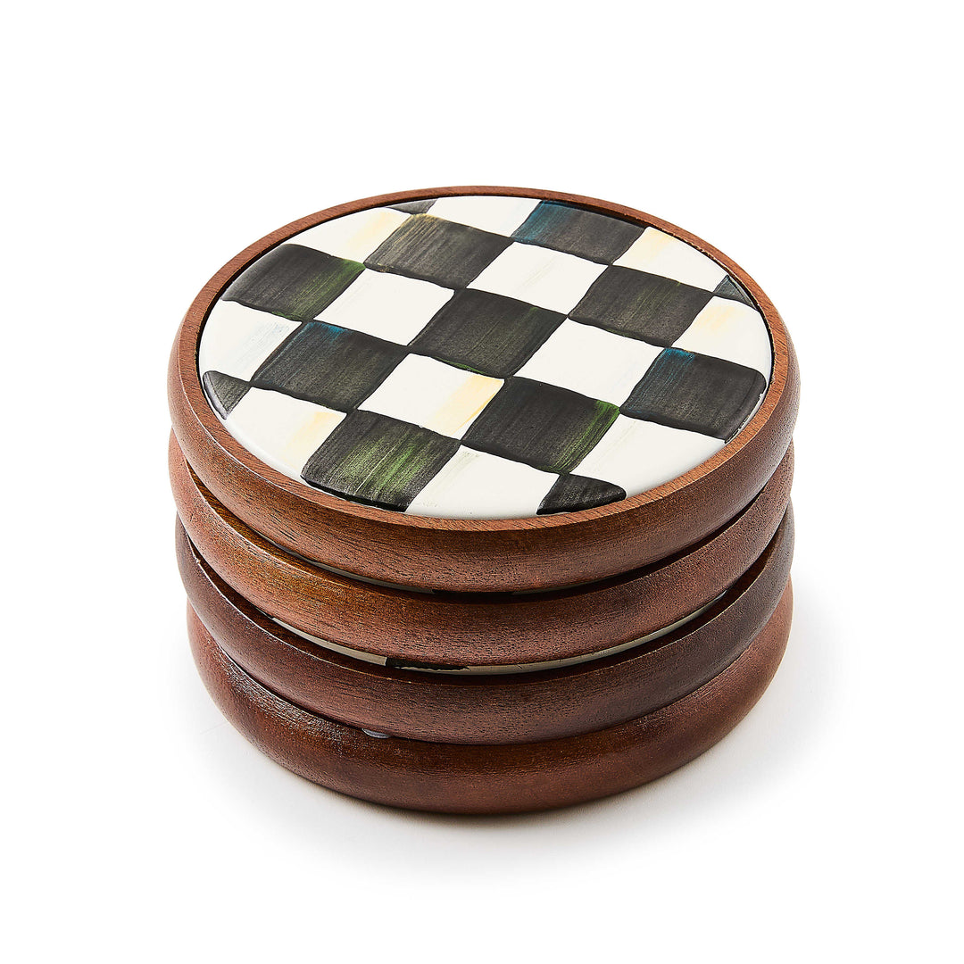 Stack of four Courtly Check enamel coasters with acacia wood bases.