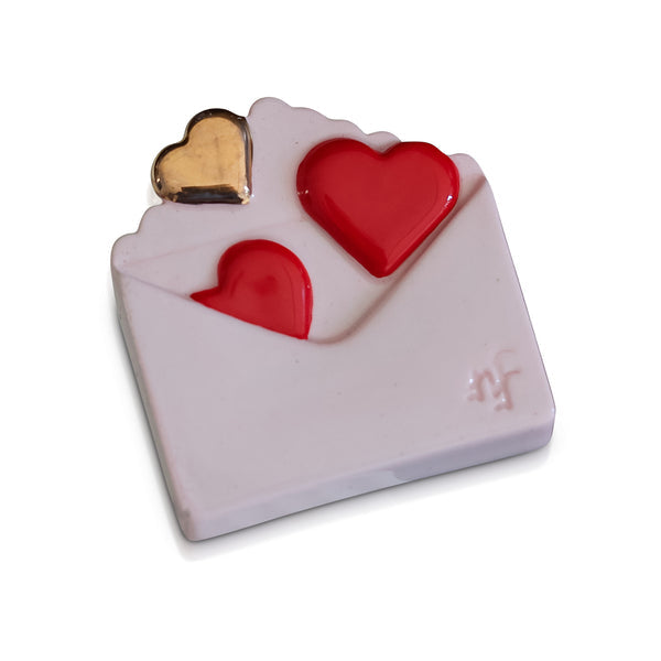 Ceramic envelope-shaped decorative piece with two red hearts and one gold heart popping out.