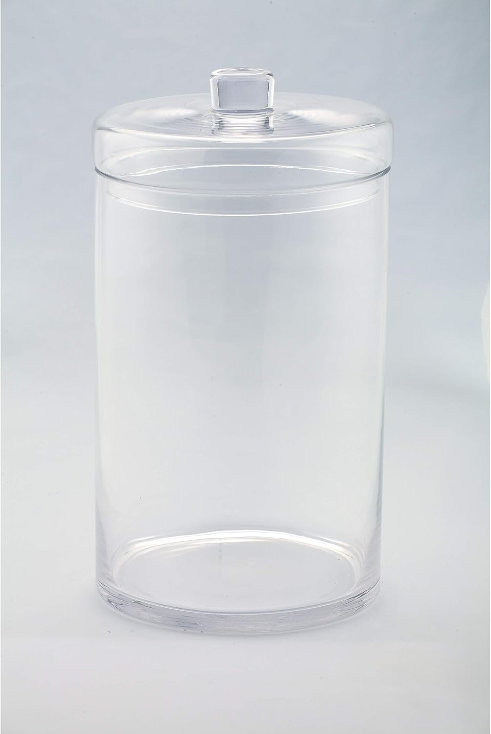 Clear cylindrical glass jar with a matching lid and round knob handle.