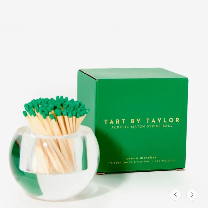 Round acrylic match strike ball with green-tipped matches next to its green box.