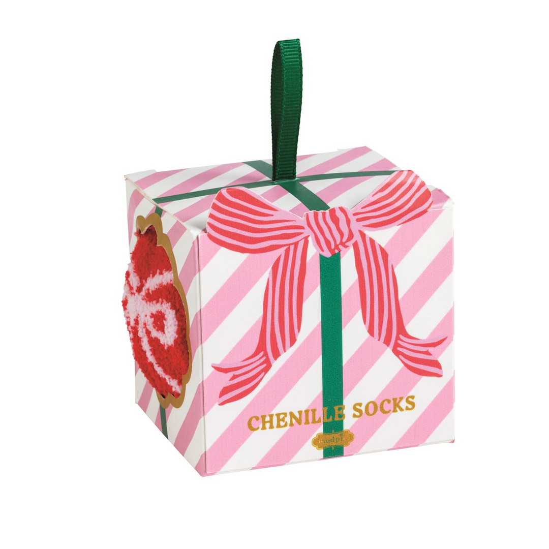 Pink and white striped gift box with a green ribbon handle containing chenille socks.